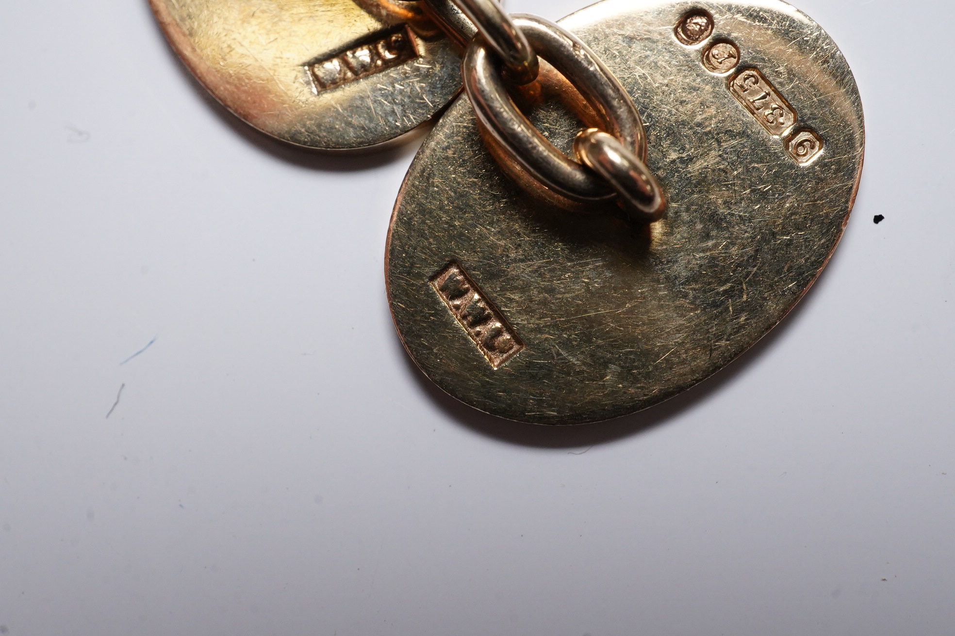 A pair of 1970's engraved 9ct gold oval cufflinks, 18mm, 11 grams. Condition - fair to good